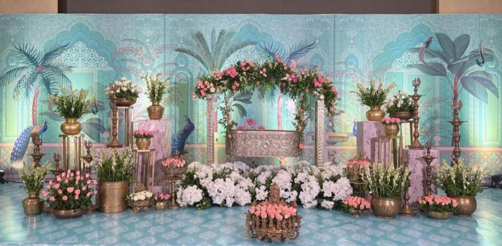 Hyderabad cradle ceremonies blend traditional naming rituals with modern, vibrant decor, including floral arrangements and bespoke "Baby in the Moon" themed backdrops.